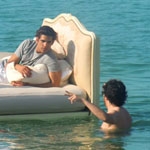 Models ride furniture out to sea on location off Miami coast for Filmmaster